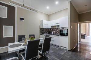 a kitchen and dining room with a table and chairs at A Golden Star Modern Luxury Apartments and Rooms Budapest in Budapest