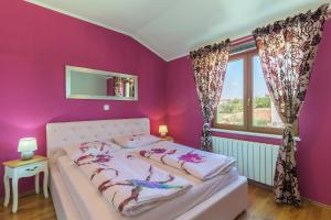 a bedroom with purple walls and a bed with a window at Villa Monique in Vodnjan +48 photos