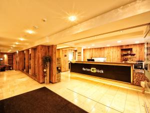 a lobby of a hotel with a sign on the wall at Hotel Ferienglück in Ischgl