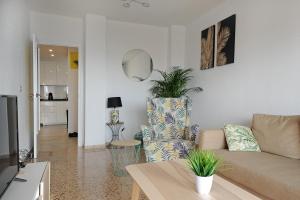 a living room with a couch and a table at Sunset in Santa Pola +14 photos