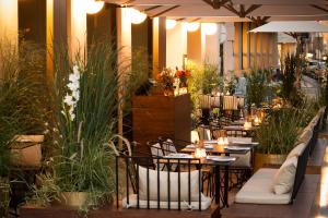 a restaurant with tables and chairs and plants at The Guesthouse Vienna in Vienna