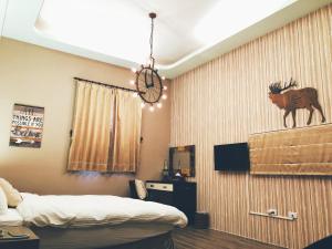 a room with a bed and a wall with a picture of a moose on at 吉祥城堡 Propitious Castle B&B in Zhixue