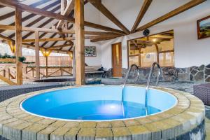 a large pool in a patio with a house at Готель PIKUY in Zhdenievo