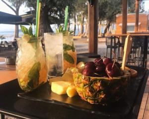 a tray of fruit and drinks on a table at Nana Hotel in Kamena Vourla +48 photos