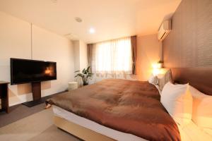 Postel nebo postele na pokoji v ubytování Hotel Tohkai