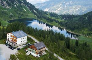 an aerial view of a building next to a lake at Hotel Alpenrose in Tauplitzalm