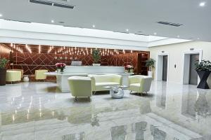 a lobby with a waiting room with couches and chairs at Brosko Hotel Arbat in Moscow
