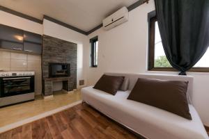 a living room with a couch and a fireplace at Apartments Vukman in Trogir
