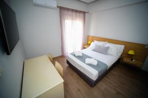 Postel nebo postele na pokoji v ubytování Sappho Studios