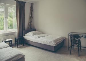 Posteľ alebo postele v izbe v ubytovaní Hotel Dwa Księżyce