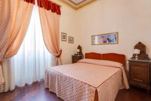 a bedroom with a bed and a window at Vittoria Street Charming in Rome