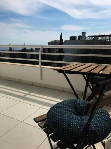 a chair and a table on the roof of a building at Olosuites in Limassol