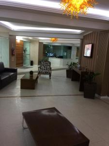a lobby with a couch and chairs in a building at Apto top, a melhor vista de Balneário Camboriú! in Balneário Camboriú +41 photos