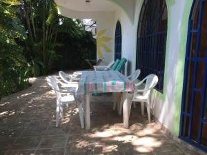 a table and chairs sitting on a patio at La Perlita in Jacó