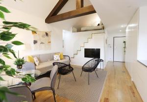 a living room with a couch and chairs at HM - OPorto City View in Porto
