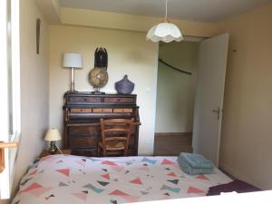 シャルネ・レ・マコンにあるChambre avec vue sur jardinのベッドルーム1室(ベッド1台、ドレッサー、ランプ付)