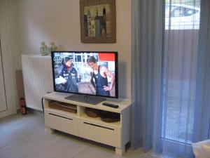 a flat screen tv sitting on a stand in a living room at Muses Studios Sami in Sami