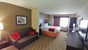 a hotel room with a bed and a couch at Best Western Palmyra Inn & Suites in Palmyra