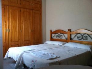 a bedroom with a bed with a wooden headboard at Chalet Cantalejo in Cantalejo