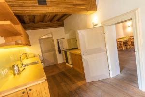a kitchen with a white refrigerator and a table at Schwarzes Haus in Ybbsitz +24 photos