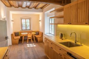 a kitchen with a table and a dining room at Schwarzes Haus in Ybbsitz