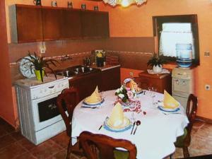 a kitchen with a table with hats on it at Apartman Kalinka in Gajić