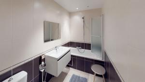 a bathroom with a sink and a toilet and a shower at Deluxe Apartment with Shared Pool in Ostend