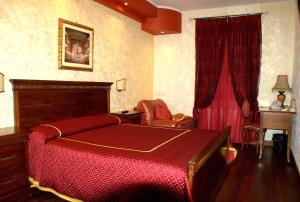 a bedroom with a bed with a red blanket at La Portella in Fabriano