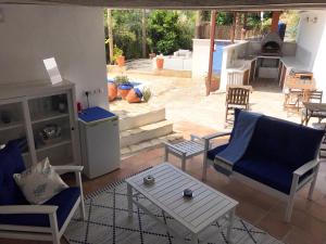 a living room with two chairs and a table at Casa Mallarenga Rooms in Olivella