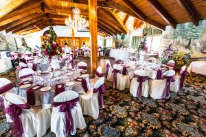 a banquet hall with tables and chairs and a chandelier at Madonna Inn in San Luis Obispo +37 photos