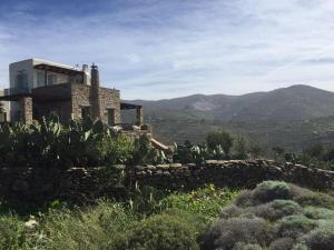 a house on a hill with a stone wall at The Hill Top House in Kea in Ioulis