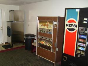 a pepsi vending machine next to a refrigerator at Shanico Inn in Lebanon