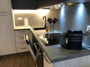 a kitchen with a stove and a counter top at PETITE MAISON a 50 passi dalla funivia !!! in Courmayeur