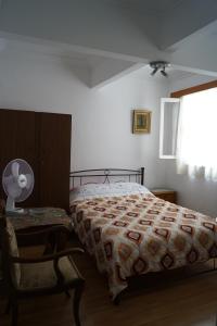 a bedroom with a bed and a chair and a window at ★ Plaka, Center of all Greek Legends ★ in Athens