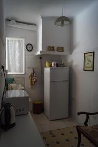 a kitchen with a white refrigerator and a window at ★ Plaka, Center of all Greek Legends ★ in Athens