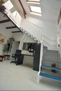 - un escalier blanc dans une chambre avec un bureau dans l'établissement CASA ADO, à Oradea