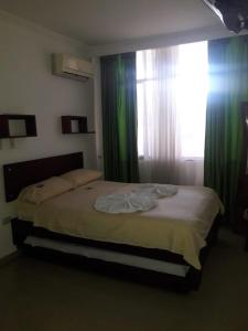 Postel nebo postele na pokoji v ubytování Hotel Orquidea Dorada R