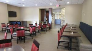 a dining room with tables and red chairs at MainStay Suites Coeur d'Alene in Coeur d'Alene