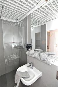 a bathroom with a sink and a mirror at Wroclaw City Apartments in Wrocław