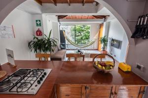 a kitchen with a bowl of fruit on a counter at Poblado Guest House in Medellín
