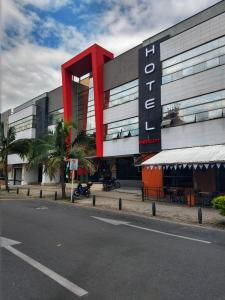 a building with a large red sign on the side of it at Hotel Merlott 70 in Medellín