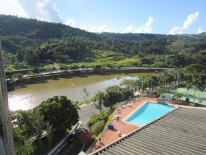 a view of a river with a swimming pool at Flat Cavalinho Branco (40A) in Águas de Lindoia