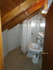 a bathroom with a toilet and a sink at Nicolas Rooms in Fiskardo +27 photos