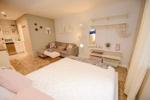 a small room with a bed and a couch at Newly Renovated Whistler Studio in Whistler +12 photos