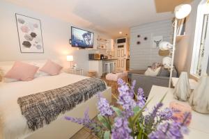 a bedroom with a bed and a living room at Newly Renovated Whistler Studio in Whistler