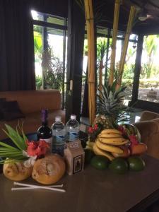 a table with a bunch of fruit and bottles of water at Villa Guarias in Puntarenas