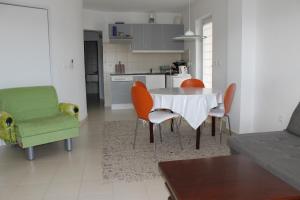a kitchen and a living room with a table and chairs at Apartments Vila Marica in Rabac