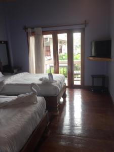 Cama o camas de una habitación en Pongkham Residence