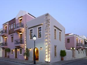 a row of houses on a street with a street light at Palazzo Vecchio Exclusive Residence in Rethymno