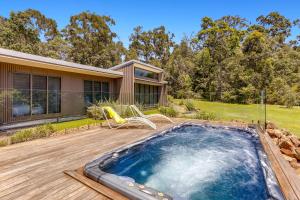 a backyard with a swimming pool and a house at Calanthe Acreage - Doonan in Doonan